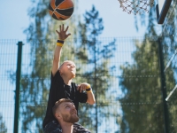 Dad and son playing basketball outdoors. Basketball player kid boy on father\'s shoulders throw ball to hoop